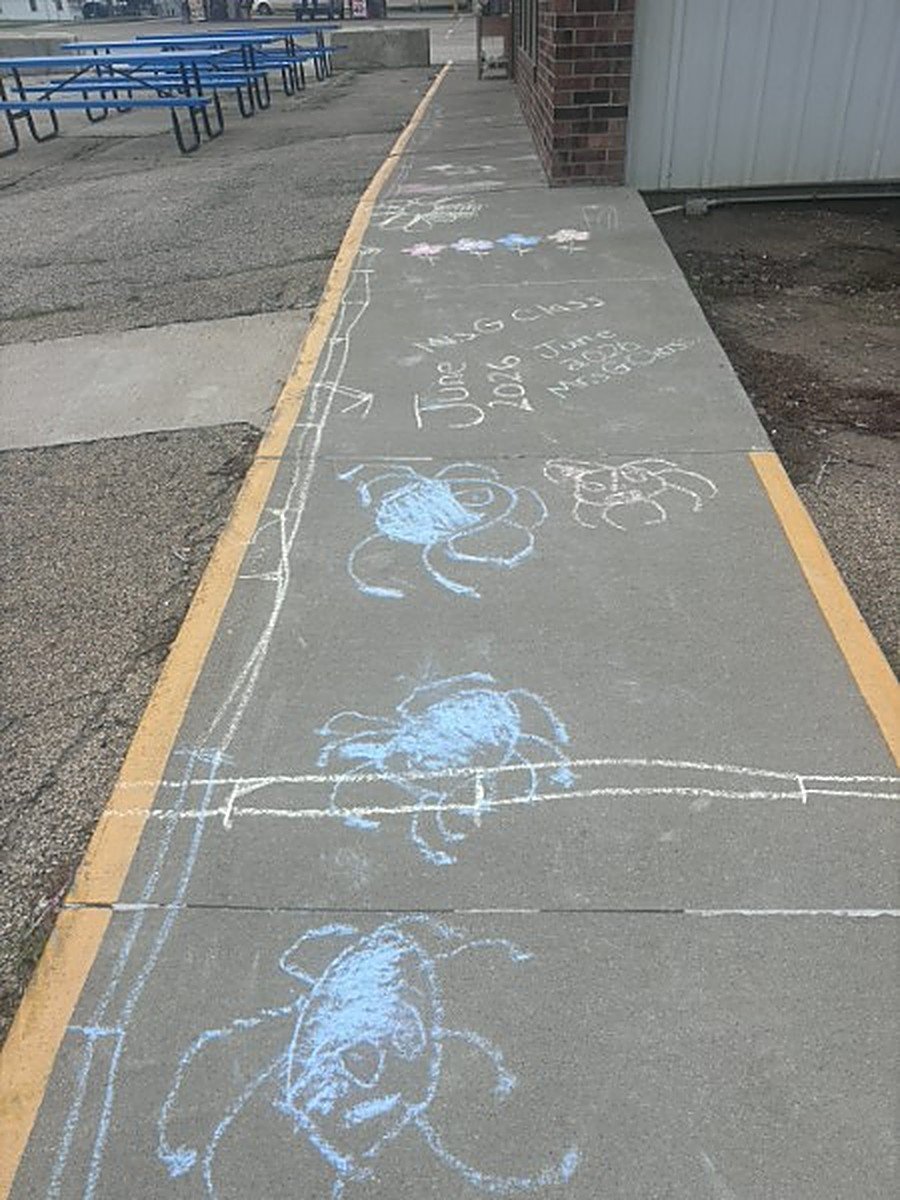 A participant creating sidewalk chalk art